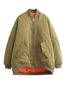 Detailed flat lay of oversized bomber jacket with bright orange quilted lining detail
