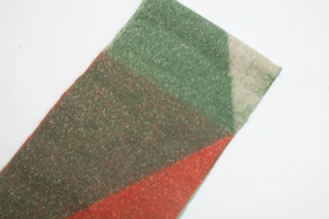 Macro shot of thick fringe and soft brushed jacquard fabric on the winter scarf