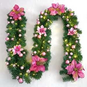 Close-up of 2.7m Christmas garland with pink poinsettia flowers and warm LED lights