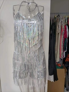 Detail of shimmering silver sequins and fringe tassels on a sexy summer strap dress