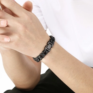 Detail of 13mm vintage patterned black Cuban chain bracelet worn on male wrist