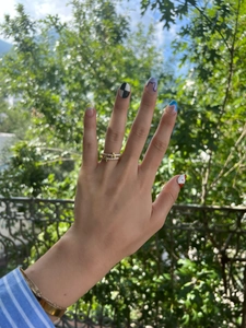 Detail of stacked gold open rings with micro-pave zircon A and T letter pendants