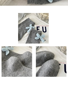 Detail of wool knit socks in grey featuring light blue ribbon bows and textured stitch