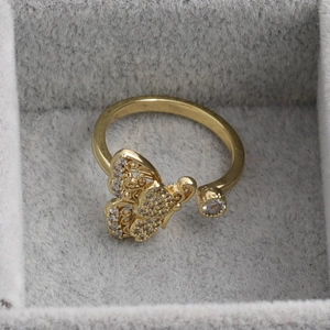 Adjustable golden butterfly ring with zircon accents in a velvet jewelry gift box