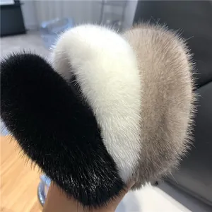 Detailed view of plush faux mink fur headbands in black, white, and taupe brown