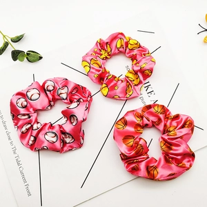 Satin scrunchies set featuring vibrant sports ball prints like baseball and basketball