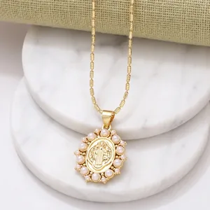 Golden religious heart pendant necklace with pearls and zircon on marble base