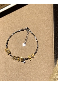 Close-up of S925 silver beaded bracelet with citrine stones and zircon heart pendant