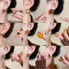Collage of amber floral earrings with pearls and gold metal tassels for women
