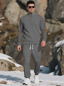 Outdoor shot of men's dark grey knitted tracksuit with jacquard pattern and stand collar