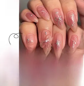 Detail of pink gradient 3D press-on nails with silver stars and 3D butterfly charms