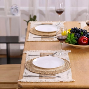 Detail of Nordic double-layer linen placemat with fringe and natural round woven mat