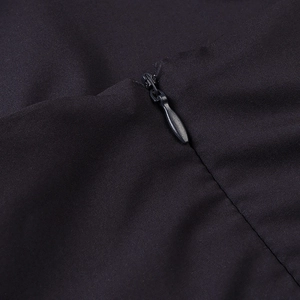 Detailed macro view of the seamless invisible zipper on premium black textile fabric
