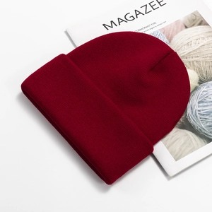 Detail of burgundy ribbed knit beanie showing high-quality thick cuff and soft texture