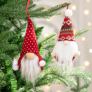 Festive Christmas tree gnome ornaments with red and green knit caps on pine branches