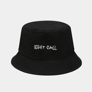 Close-up of black cotton bucket hat featuring white Night Call letter embroidery