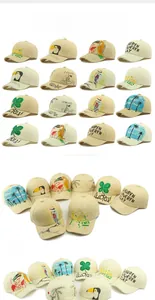 Detail of hand-painted straw baseball cap with tropical birds and coconut tree patterns