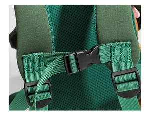Detail of breathable mesh shoulder straps and adjustable chest buckle on green backpack
