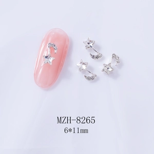 Close-up of silver moon and star nail charms with dimensions 6x11mm on pink nail tip