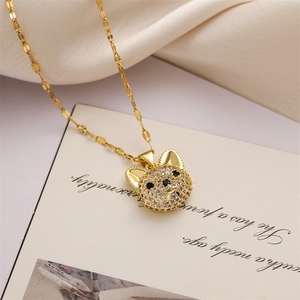 Close-up of gold bulldog necklace pendant with sparkling crystals on beige fabric