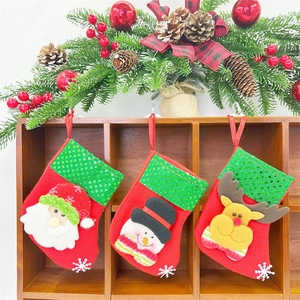 Hanging Christmas mini stockings featuring Santa, Snowman and Reindeer on a wooden rack