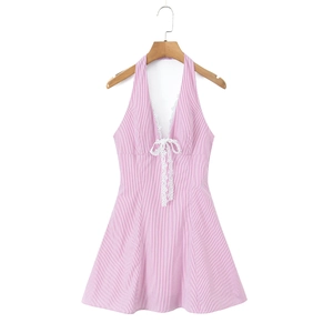 Detail of pink and white striped halter dress featuring lace trim and a deep V-neckline