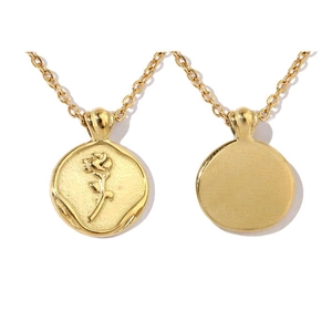 Detail of 3D rose flower relief on a round gold pendant with a thin stainless steel chain