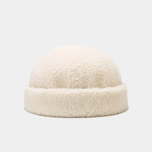 Detail of soft cream-white sherpa lamb wool docker hat with a rolled cuff design