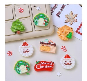 Flat lay of resin Christmas DIY charms featuring Santa, gingerbread man and festive trees