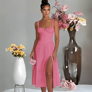 Detail of pink satin midi dress featuring corset bodice design and elegant side leg slit