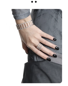 Detailed view of silver geometric open ring with shimmering pavé diamond inlay on a hand