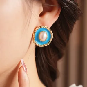 Vintage gold oval earrings with blue enamel, pearls, and hammered metal texture