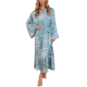 Detail of light blue silk-like long robe showing fluid abstract wave print and sash tie