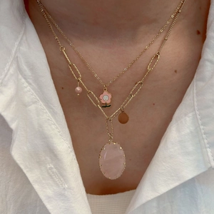 Three-layer gold necklace with pink crystal, floral charm, and beaded accents for women