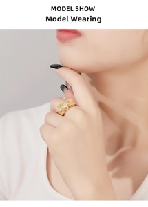 Close-up of model wearing a gold ginkgo leaf ring with sparkling white diamonds