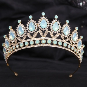 Detailed macro view of mint green crystals and white rhinestones on a gold bridal crown