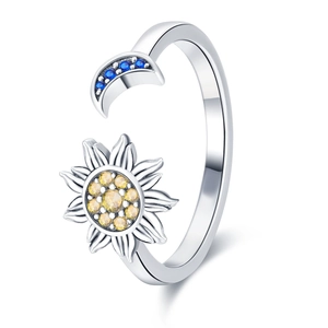 Detailed shot of open ring featuring blue moon and yellow sun gemstones on silver band