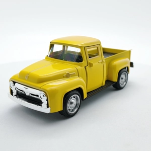 Macro detail of classic yellow vintage alloy pickup truck toy with silver bumpers