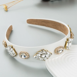 Macro shot of white wide headband with sparkling crystal clusters and non-slip lining
