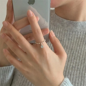 Close-up of 925 sterling silver beaded ring with a polished round charm on hand