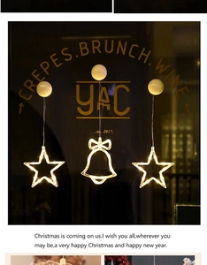 Detail of warm white LED Christmas window suction lights in star and bell shapes