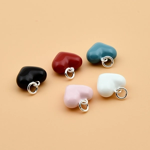 925 sterling silver heart pendants in five colors on a soft orange background