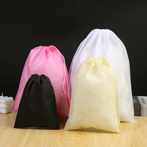 Non-woven drawstring storage bags in four colors on a professional studio background