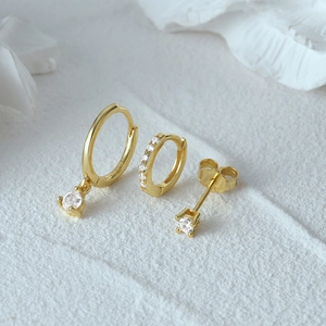 Three-piece gold S925 silver earring set featuring evil eye charms and sparkling crystals