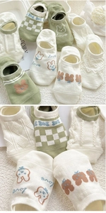 Detail of green and cream cotton no-show socks with cute rabbit ears and love patterns
