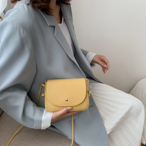 Fashionable bright yellow mini crossbody shoulder bag for women with metallic round buckle