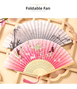 Detail of Chinese silk folding fans featuring ink bamboo and sakura rabbit patterns