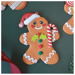 Macro shot of gingerbread man ornament with Santa hat and glittery festive details