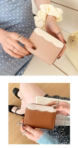 Close-up of litchi textured leather coin purse with contrast color and metal zipper