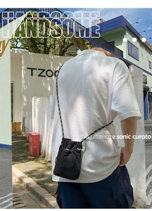 Detail showing the adjustable black and white woven strap and drawstring closure of the bag